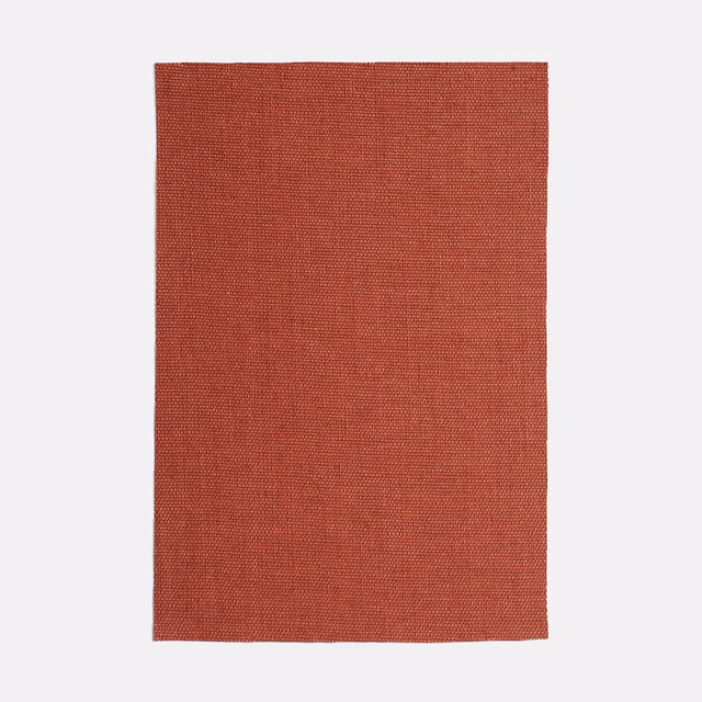 Muted rooibos-red woven upholstery swatch with a fine, subtly varied texture