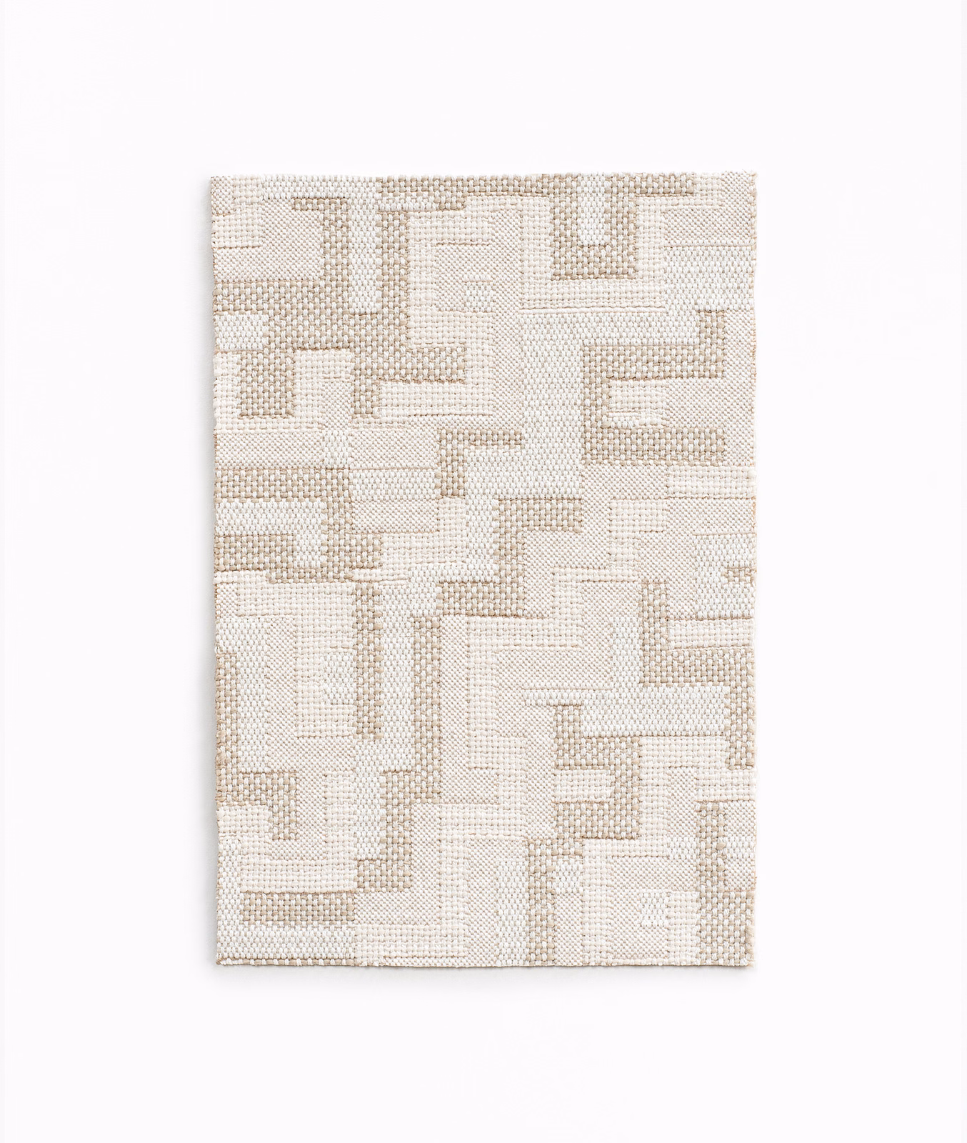Warm ecru woven swatch with raised angular maze lines and fine grid texture