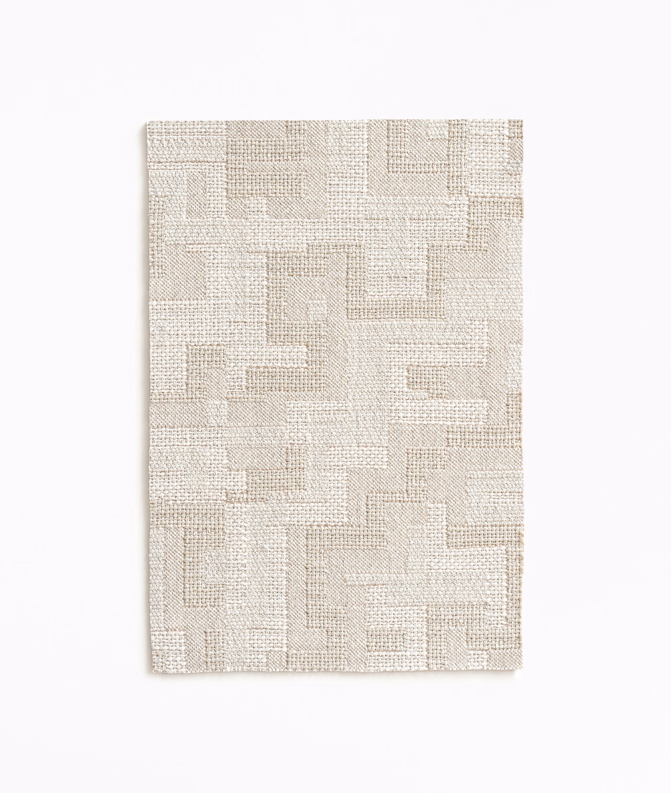 Pale linen-beige woven fabric with interlocking rectangular blocks and tactile crosshatched texture