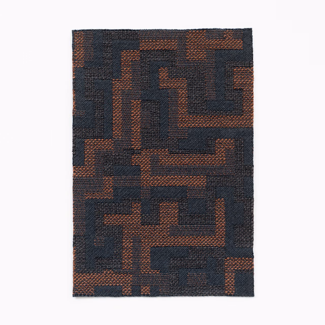 Dark charcoal woven swatch with russet maze-like geometric blocks