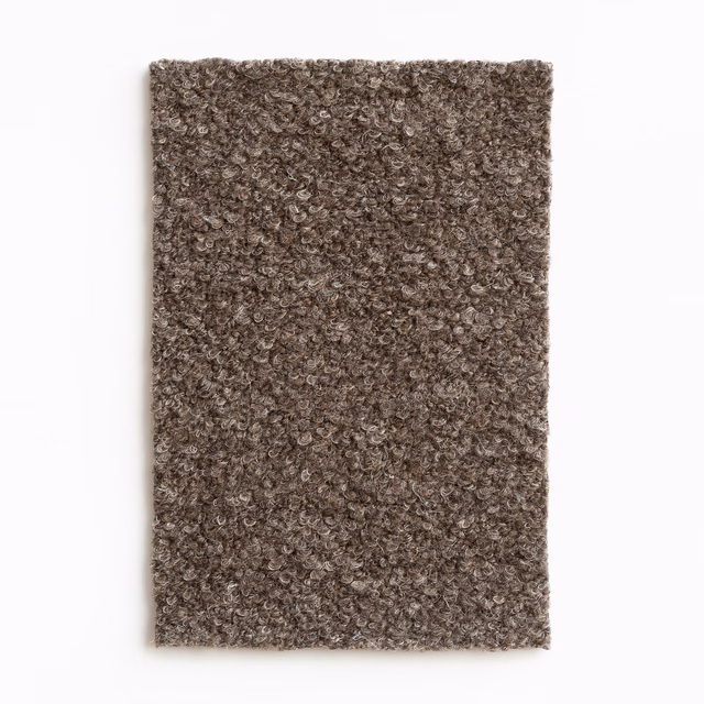 Dense brown-taupe curled upholstery texture with softly mottled boucle-like surface