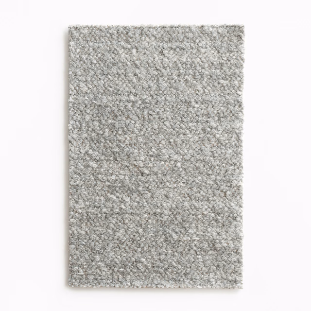 Pale warm-grey bouclé swatch with dense nubby loops and subtle flecking