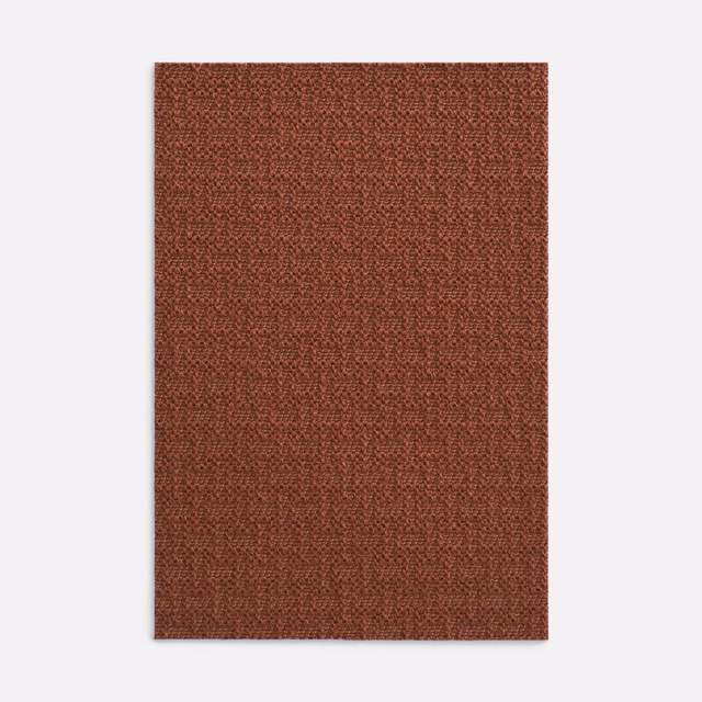 Warm russet terracotta upholstery textile with a close, pebbled woven surface