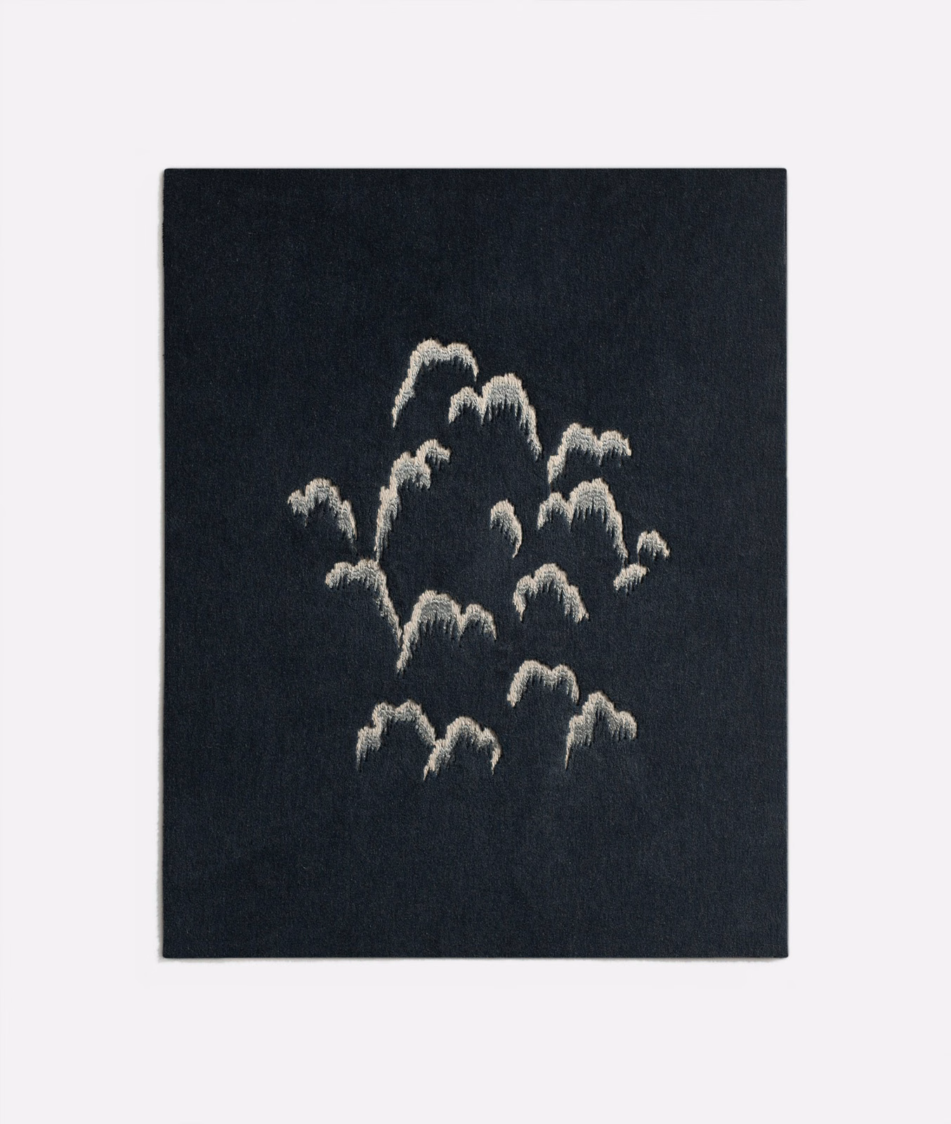 Midnight-blue textured fabric with scattered pale raised abstract floral motifs