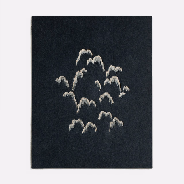 Midnight-blue textured fabric with scattered pale raised abstract floral motifs