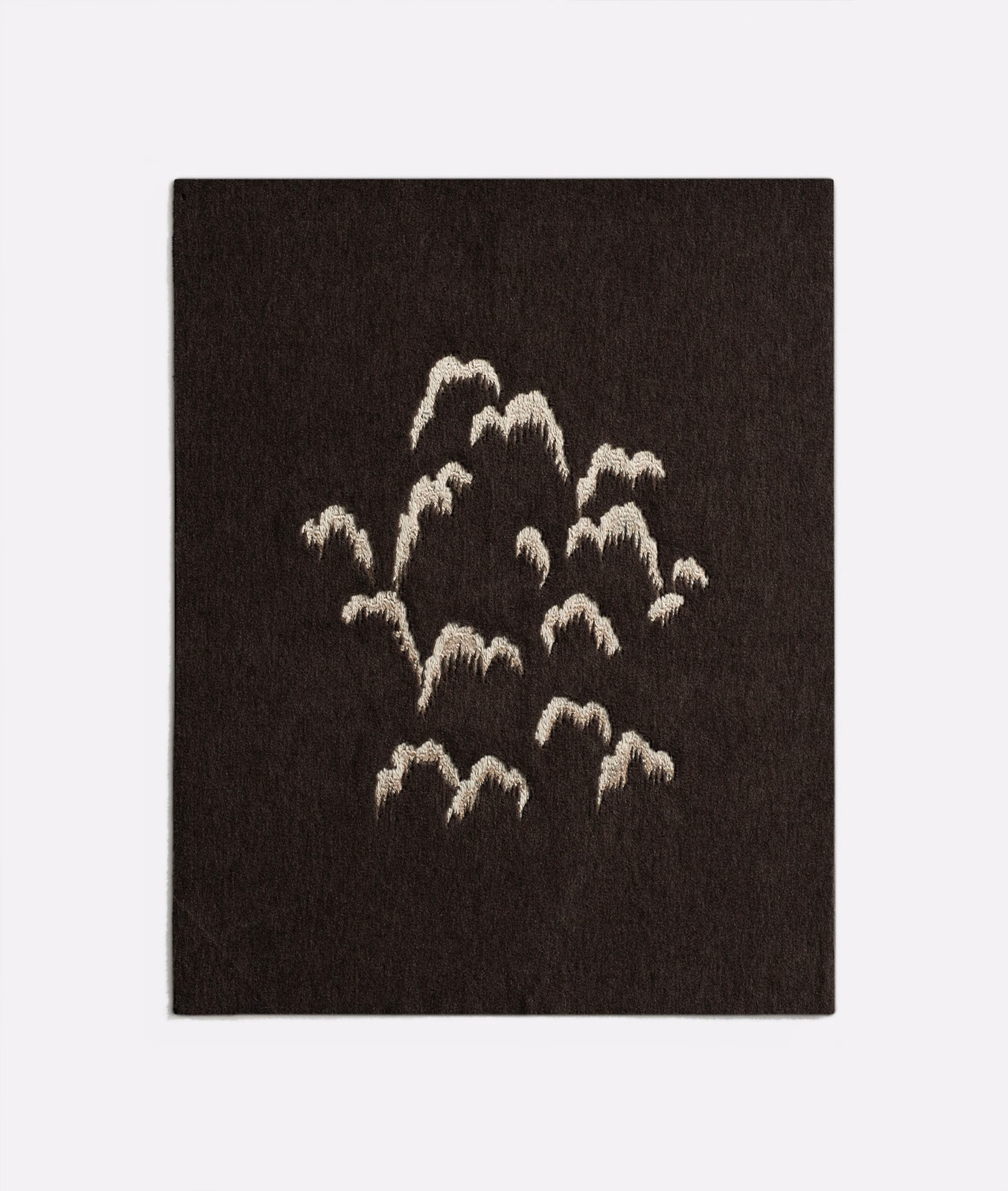 Dark espresso-brown fabric with clustered ivory brushstroke motifs and softly raised texture