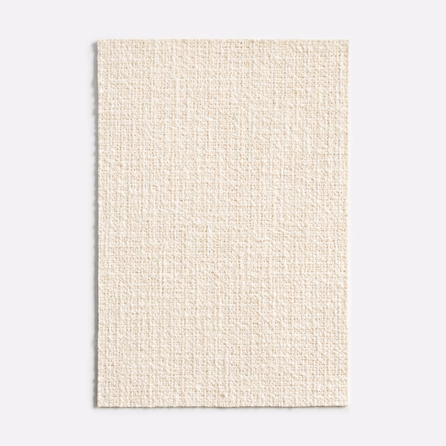Warm ivory fabric swatch showing a finely textured, subtly flecked plain weave