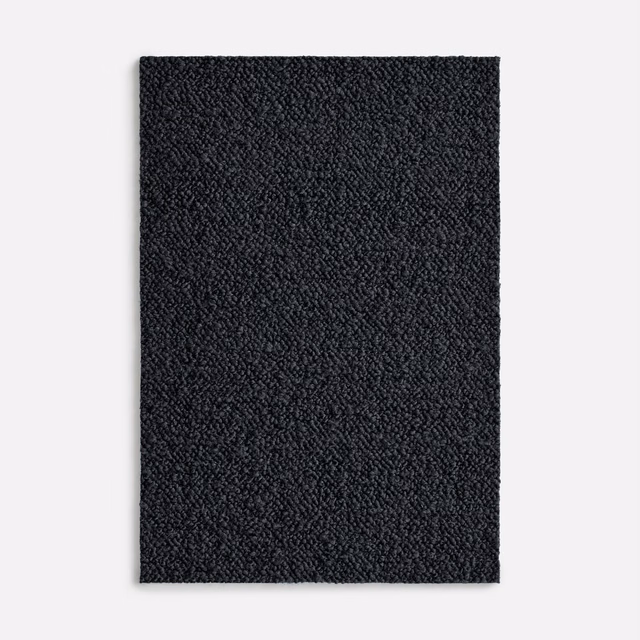 Near-black nubby textile swatch with subtle charcoal highlights and compact woven texture