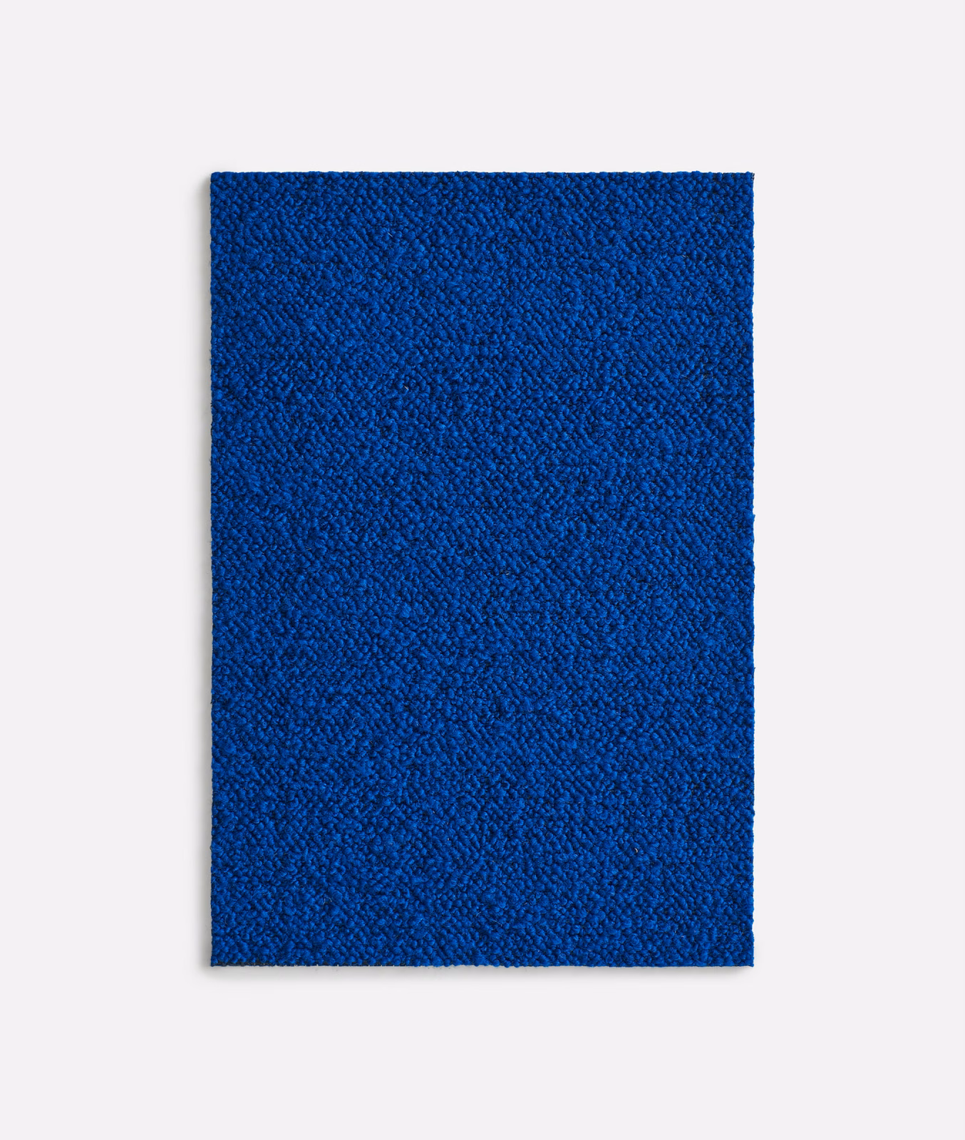 Saturated cobalt-blue textile swatch with fine irregular pebbled surface texture