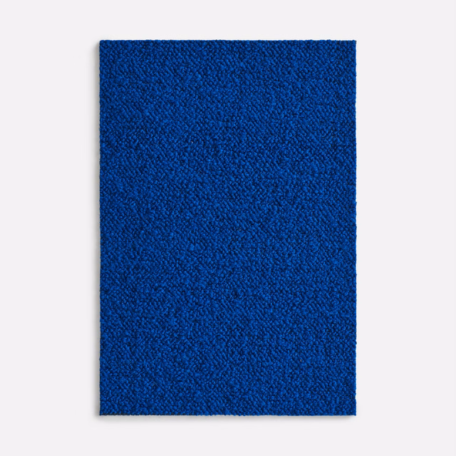 Saturated cobalt-blue textile swatch with fine irregular pebbled surface texture