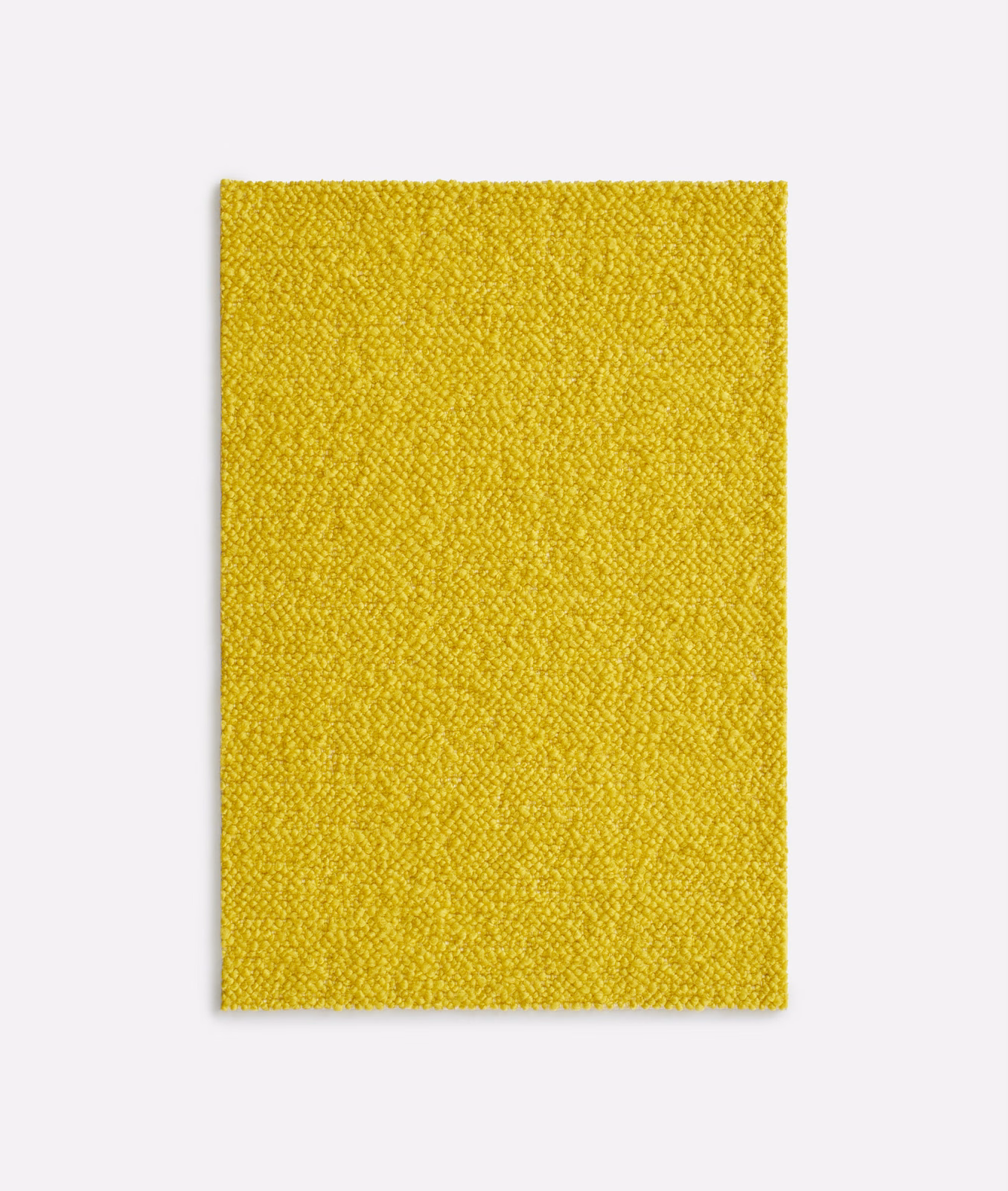 Close-up of bright sulphur-yellow nubby woven textile with a pebbled surface