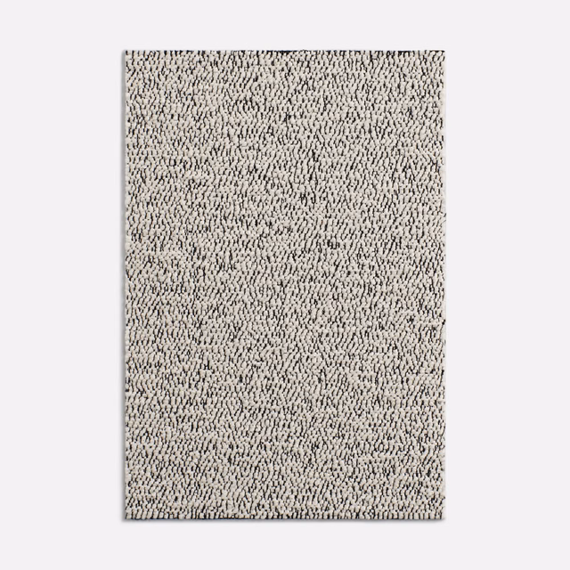 Ivory cream looped upholstery fabric with dense charcoal flecks and a nubby surface