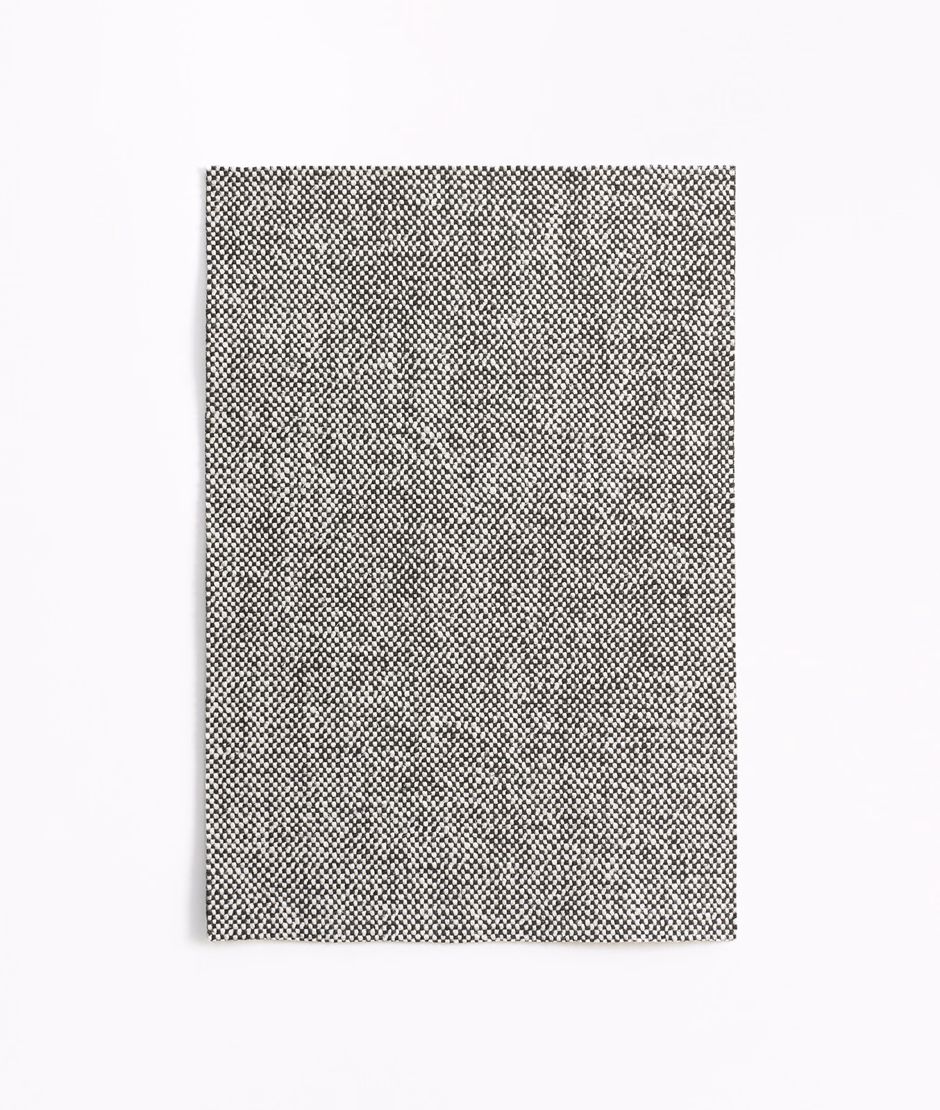 Dense warm-grey upholstery swatch with a tiny charcoal micro-check woven texture