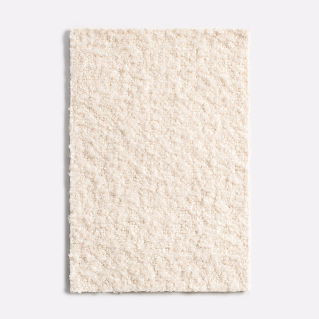 Warm ivory nubby textile with softly irregular, bouclé-like surface texture