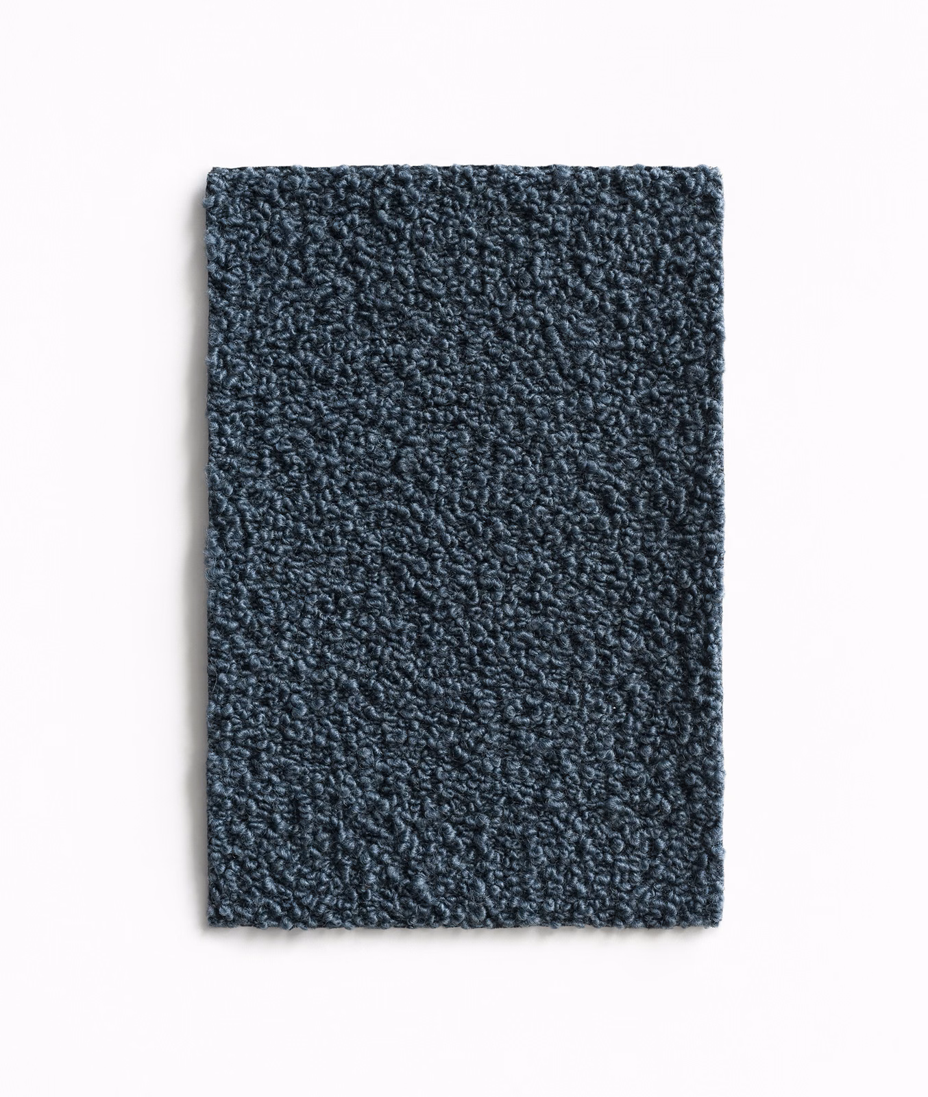 Dense nubby textile swatch in deep slate blue-grey with irregular curled loops