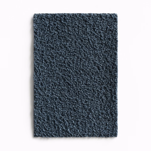 Dense nubby textile swatch in deep slate blue-grey with irregular curled loops