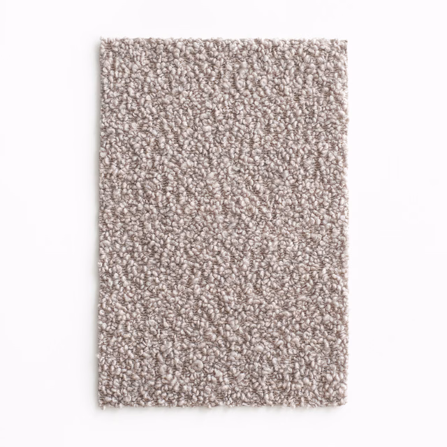 Close-up of pale taupe-grey fabric with dense irregular boucle loops and subtle flecking