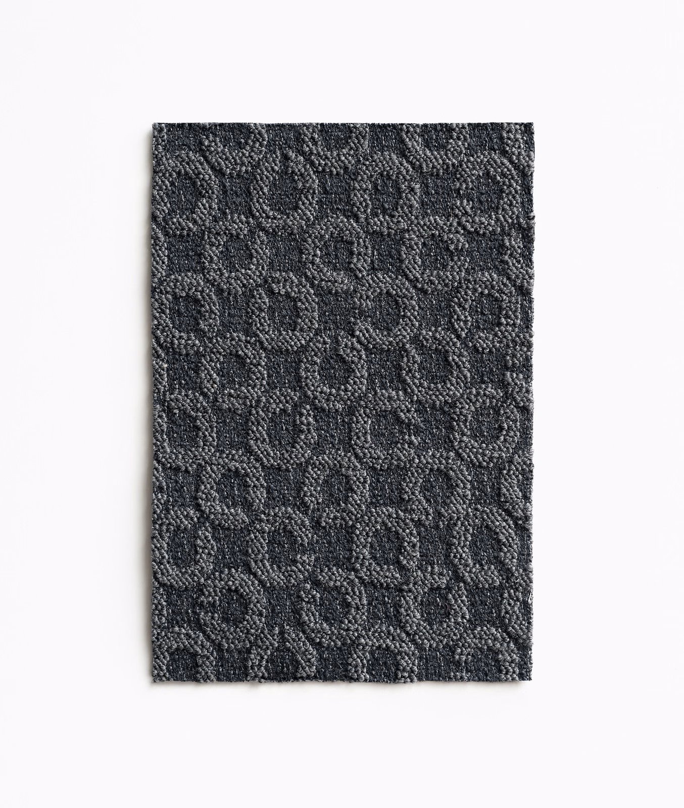Dark blue-jeans textile swatch with raised charcoal loops in a compact woven pattern