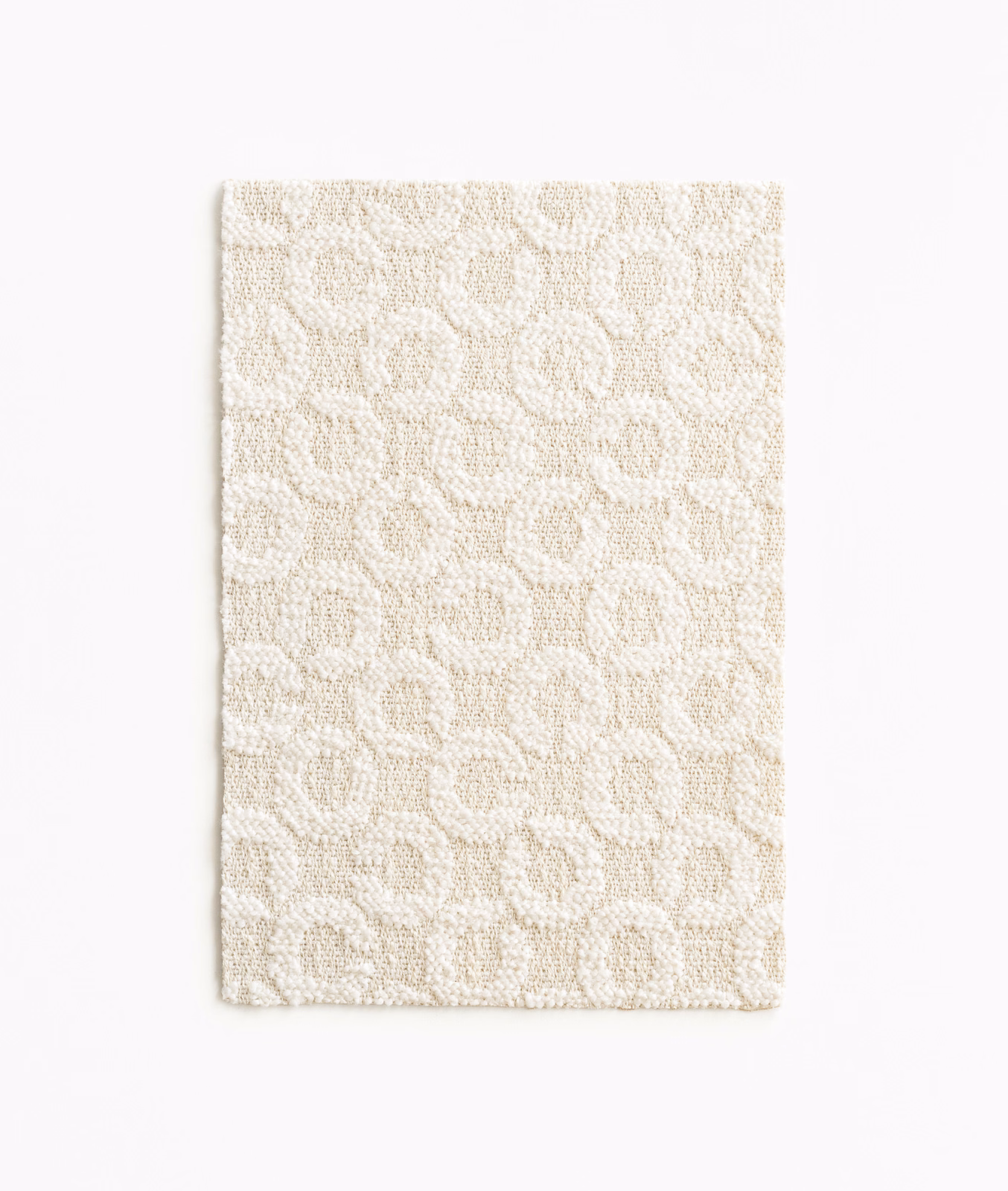 Warm ivory woven swatch with irregular rounded loops and a softly nubby texture