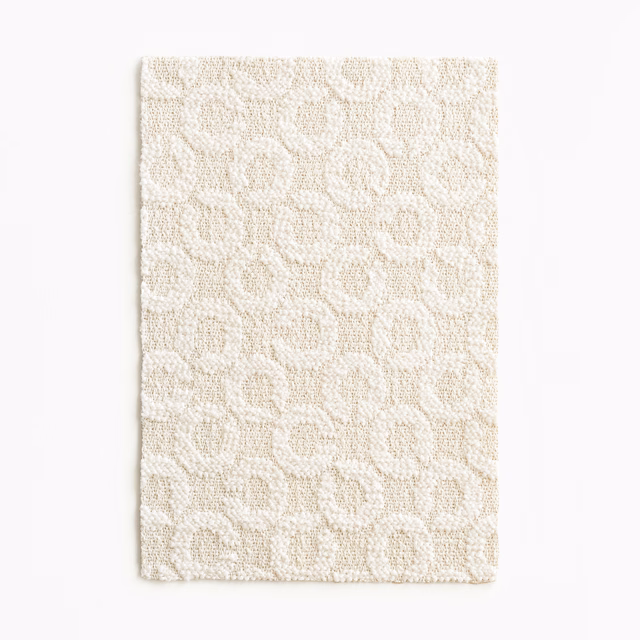 Warm ivory woven swatch with irregular rounded loops and a softly nubby texture