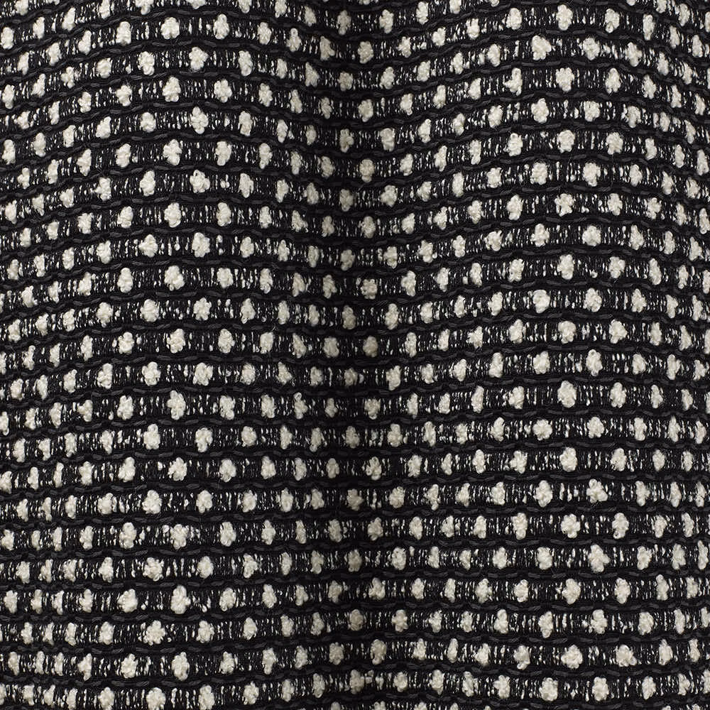 Black and ivory flecked weave forming irregular horizontal rows in close-up