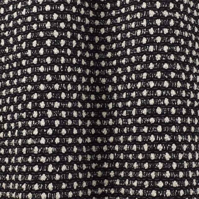 Black and ivory flecked weave forming irregular horizontal rows in close-up
