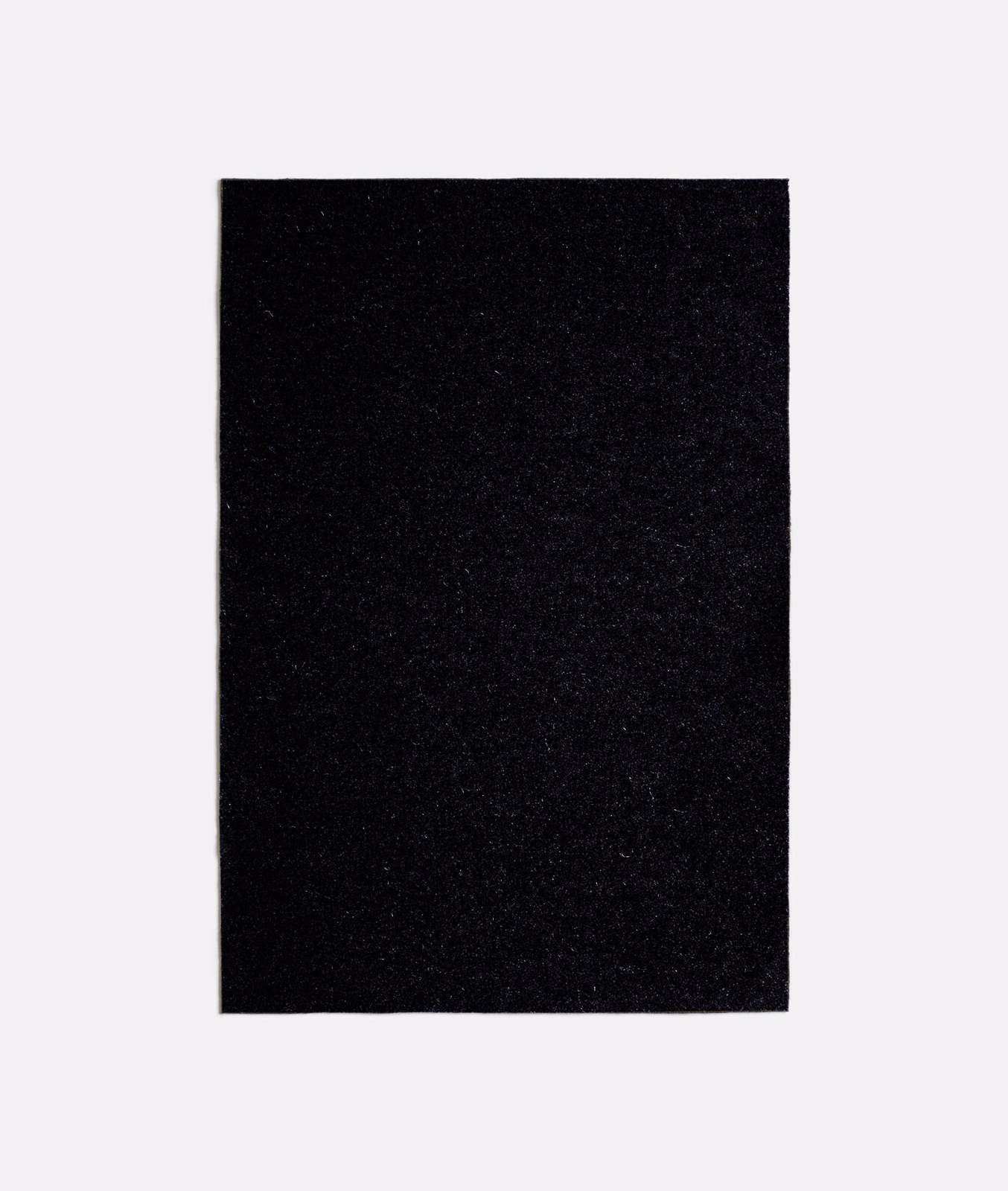 Near-black charcoal textile swatch with a dense, subtly flecked surface