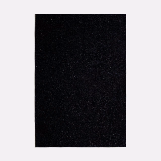 Near-black charcoal textile swatch with a dense, subtly flecked surface