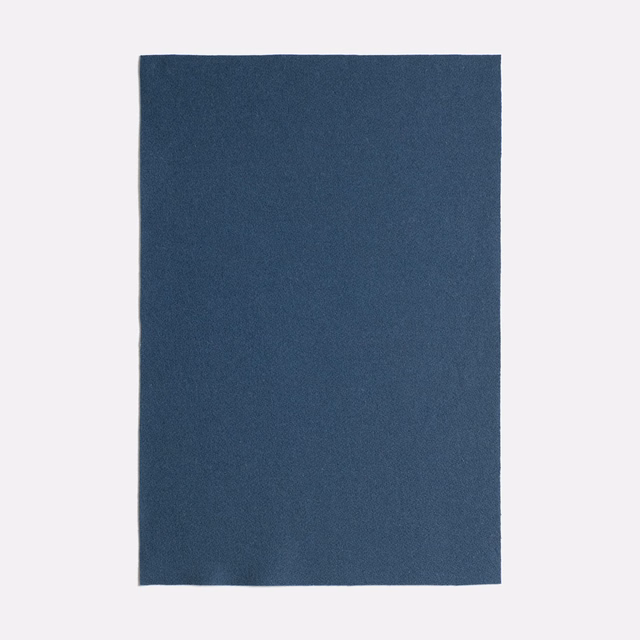 Deep blue-teal plain upholstery fabric with a subtly mottled matte texture