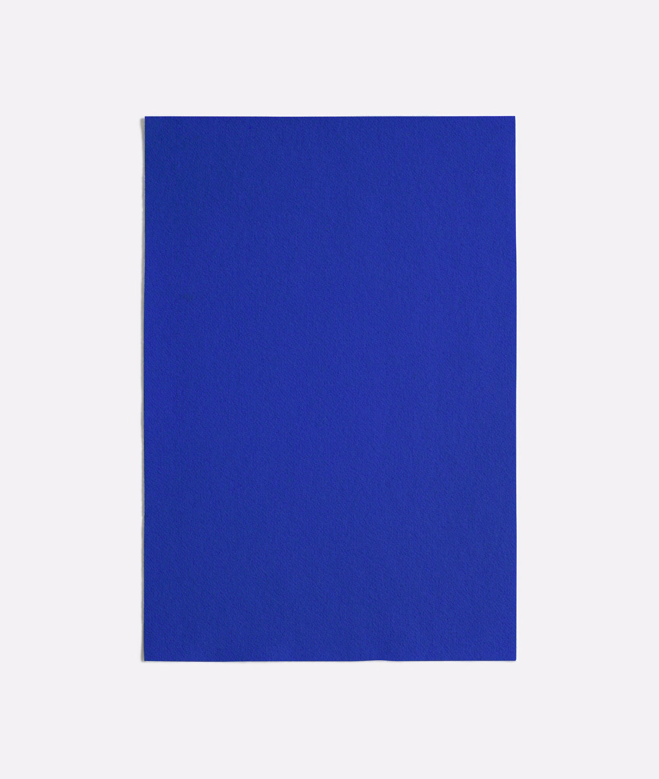 Close view of a saturated cobalt-blue woven textile with a quiet matte texture