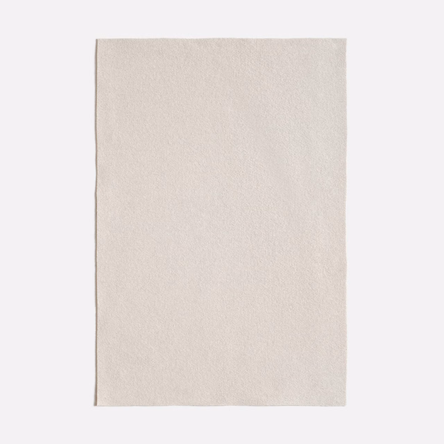 Pale natural-ivory Queneau Naturale swatch with a soft, fine-grained surface