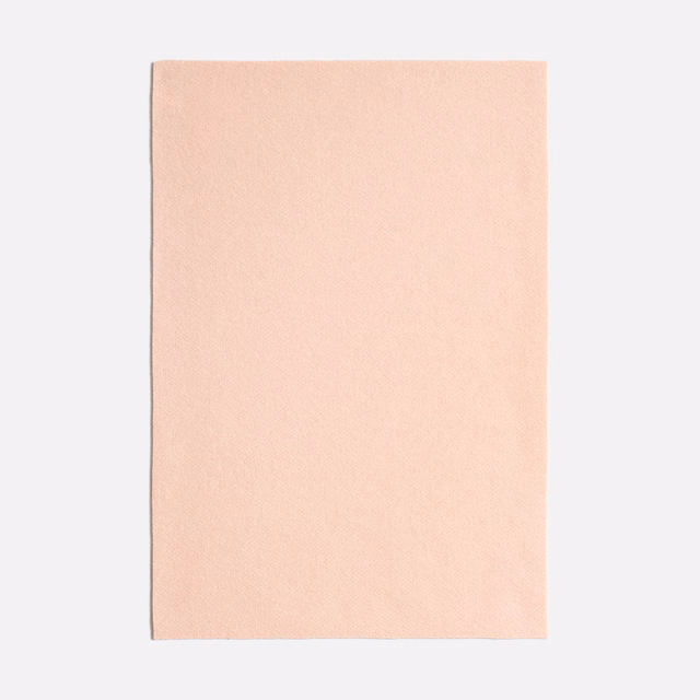 Pale blush pink Queneau Peonia fabric with a softly textured plain surface