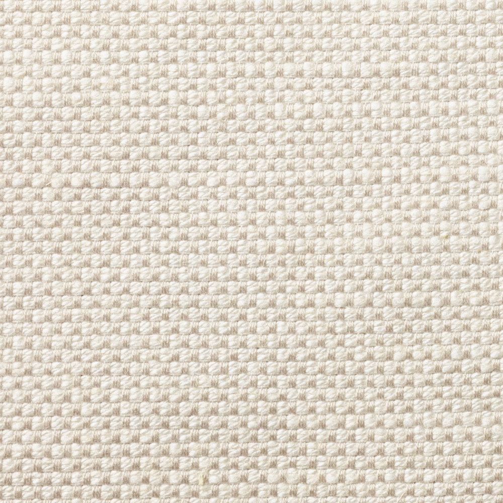 Close-up of pale ivory woven upholstery with a softly nubby, pebble-like texture