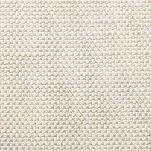 Close-up of pale ivory woven upholstery with a softly nubby, pebble-like texture