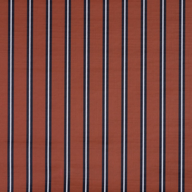 Rust terracotta textile with navy and pale vertical woven stripes