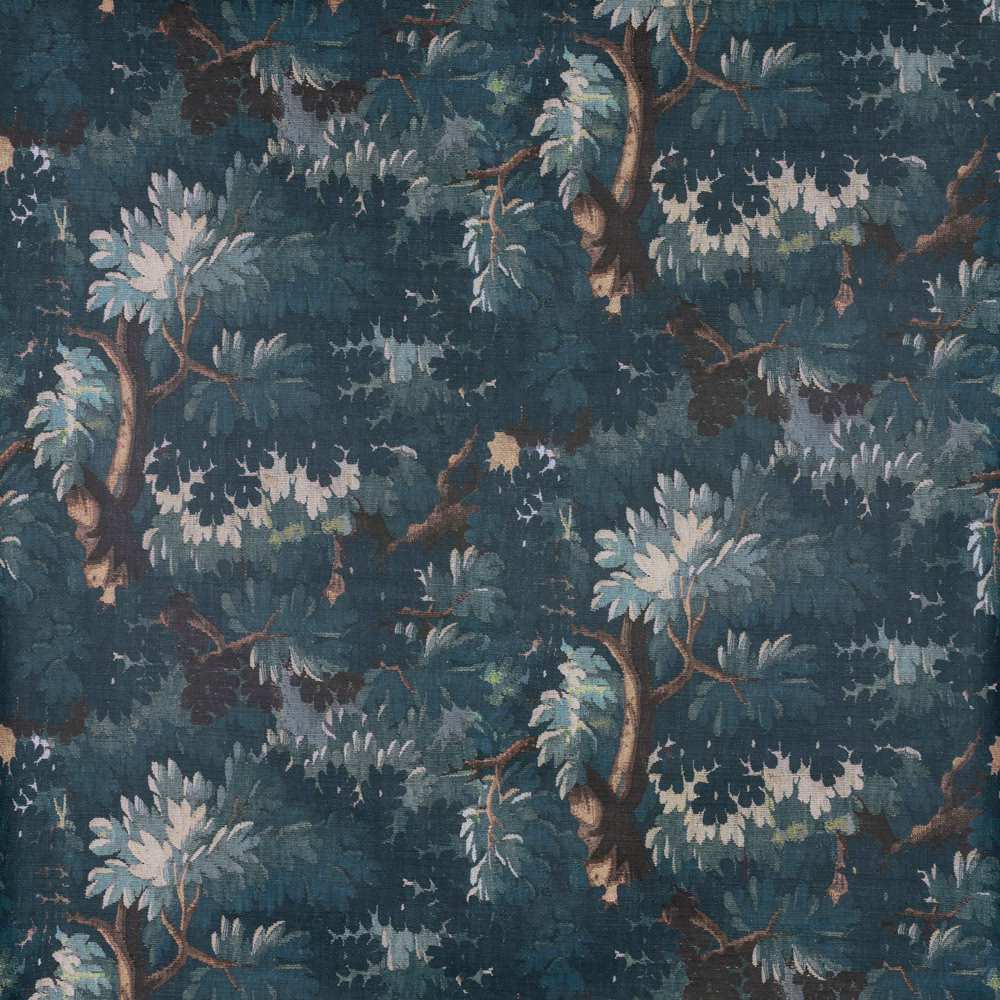 Deep blue-teal woodland fabric with pale leafy branches and brown tree trunks