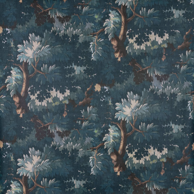 Deep blue-teal woodland fabric with pale leafy branches and brown tree trunks