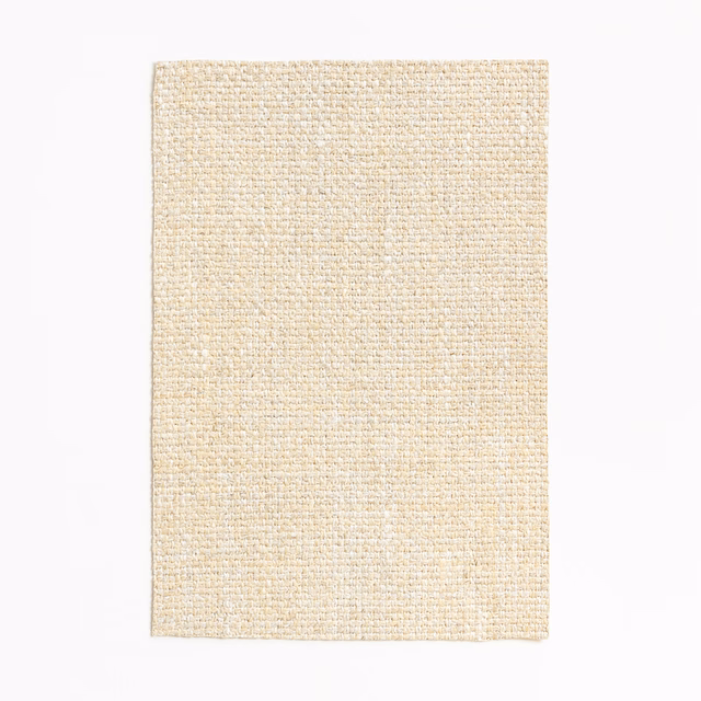 Warm ivory woven swatch with fine flecks and a softly ribbed texture
