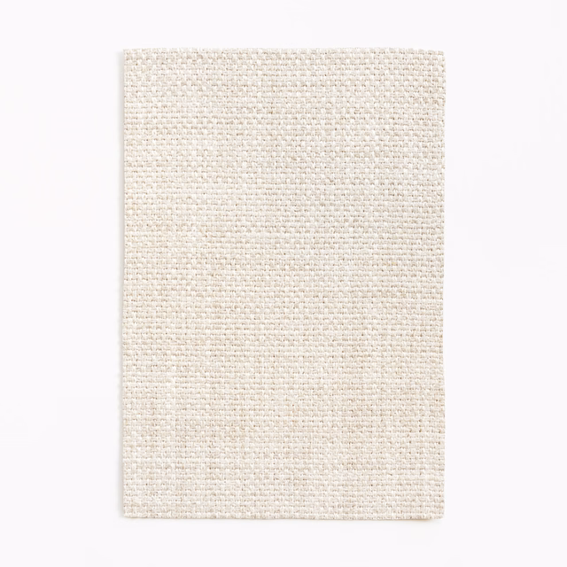 Pale chalk ivory fabric swatch with a dense, subtly flecked woven texture