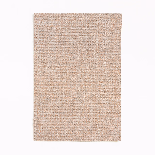 Warm peach-beige Dedar fabric swatch with fine nubby, flecked woven texture