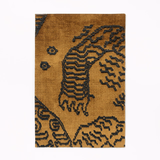 Ochre-brown woven fabric with charcoal tiger and geometric motifs