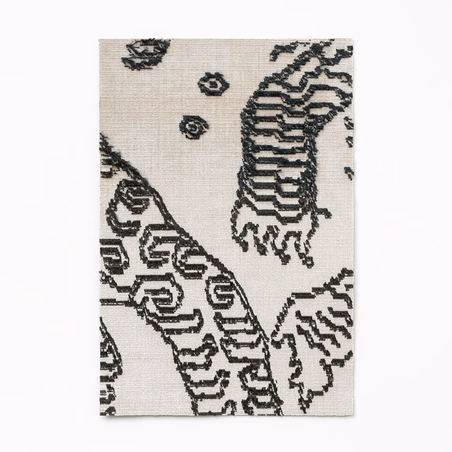 Ivory woven textile with graphite tiger-stripe motifs and small circular marks