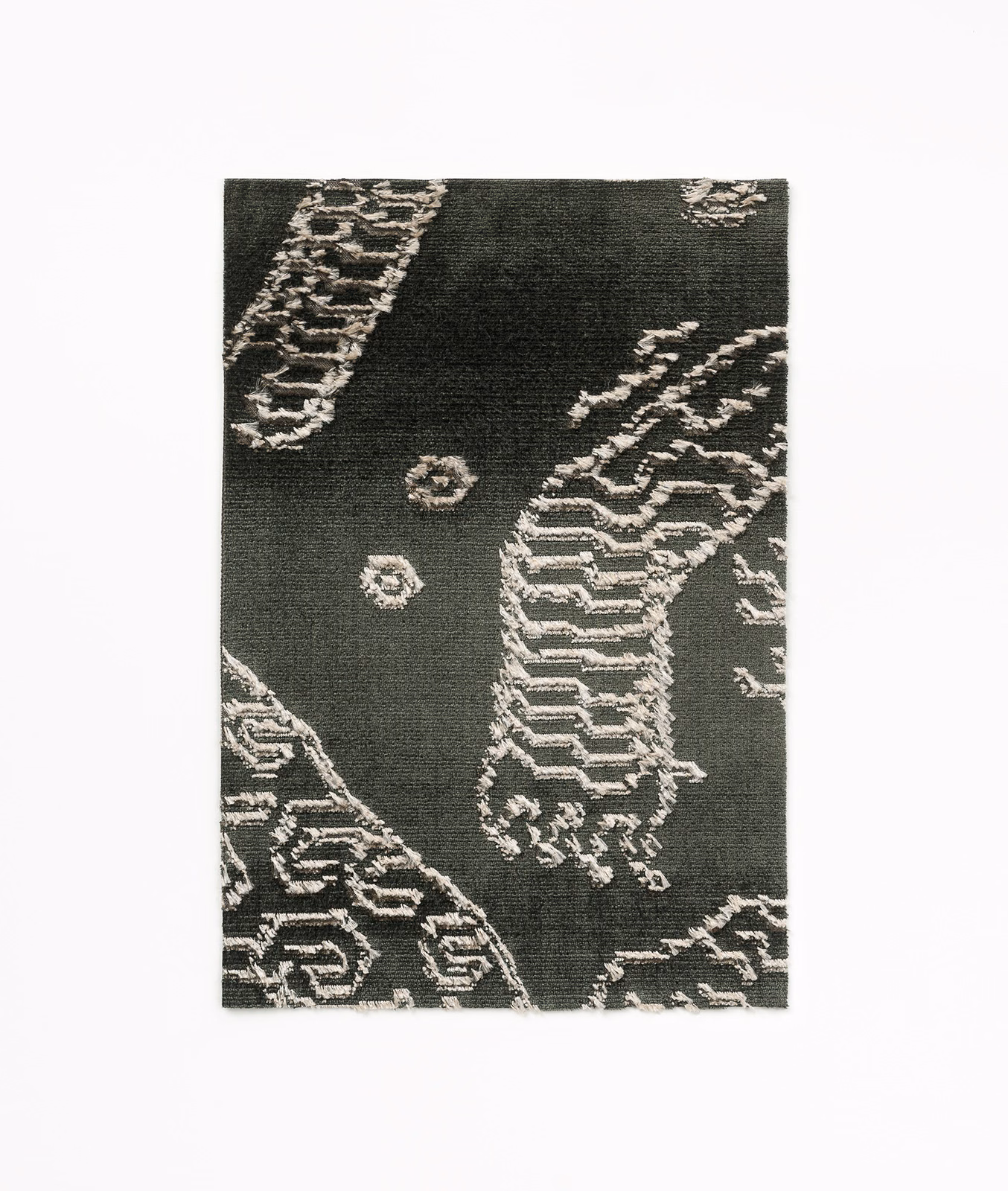 Charcoal woven fabric with pale petrified-wood lines and scattered stone-like medallions