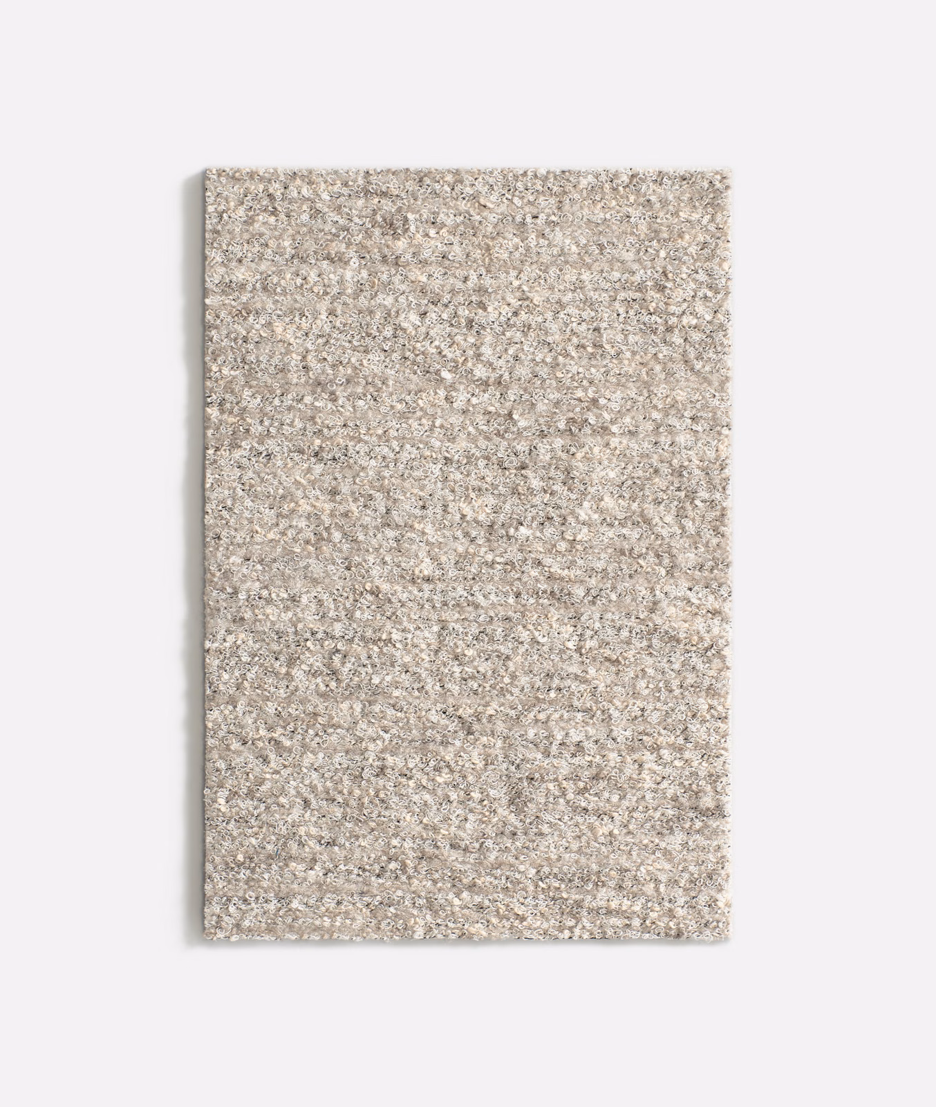 Pale pumice taupe upholstery swatch with a flecked, nubby woven texture
