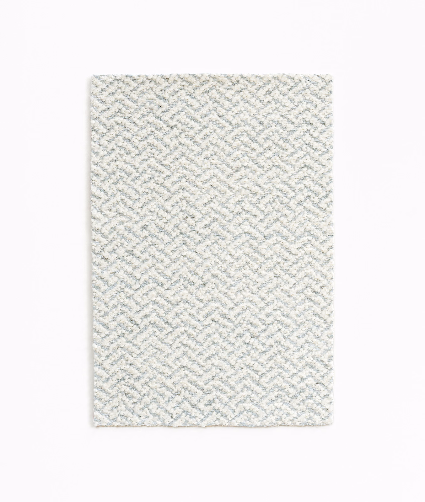Pale blue-grey fabric swatch with small raised geometric woven pattern