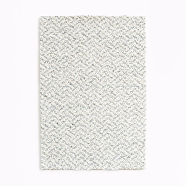 Pale blue-grey fabric swatch with small raised geometric woven pattern