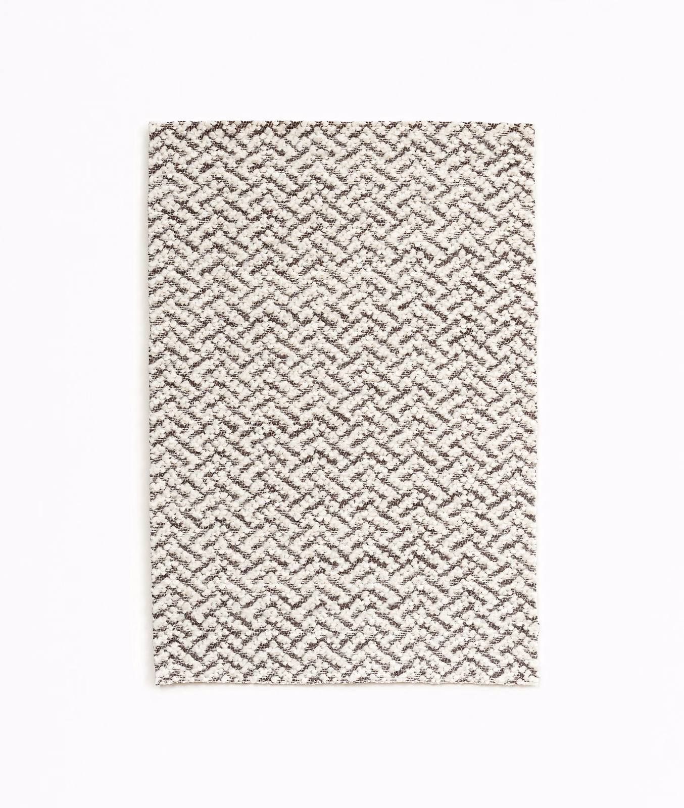Warm ivory fabric with a small taupe interlocking zigzag weave and nubby texture