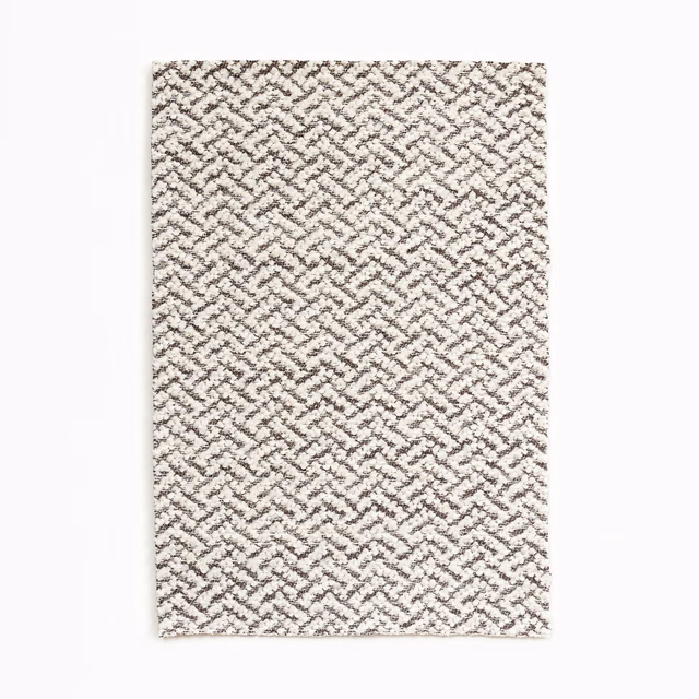 Warm ivory fabric with a small taupe interlocking zigzag weave and nubby texture