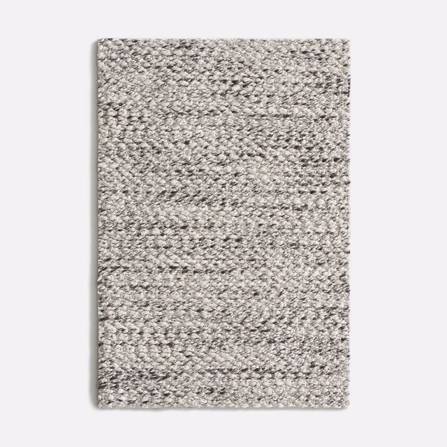 Dense nubby weave in cool mottled grey with charcoal and off-white flecks