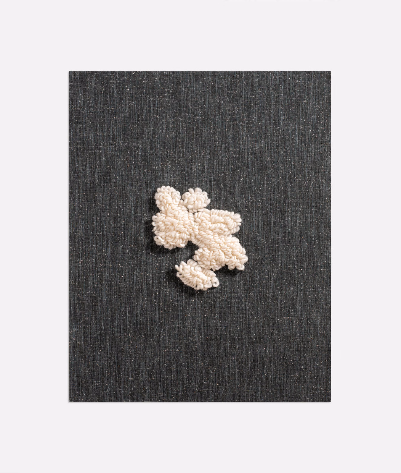 Charcoal-black woven ground with raised ivory abstract floral motif